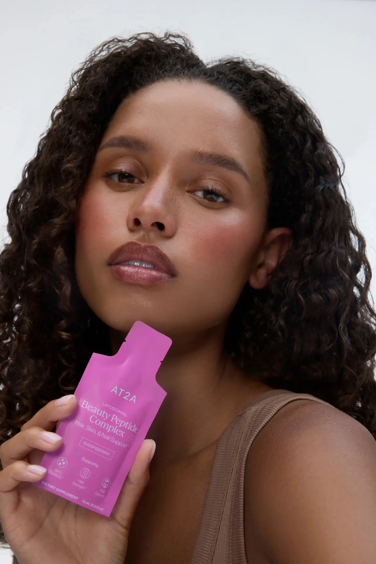 Woman holding AT2A Beauty Peptide Complex